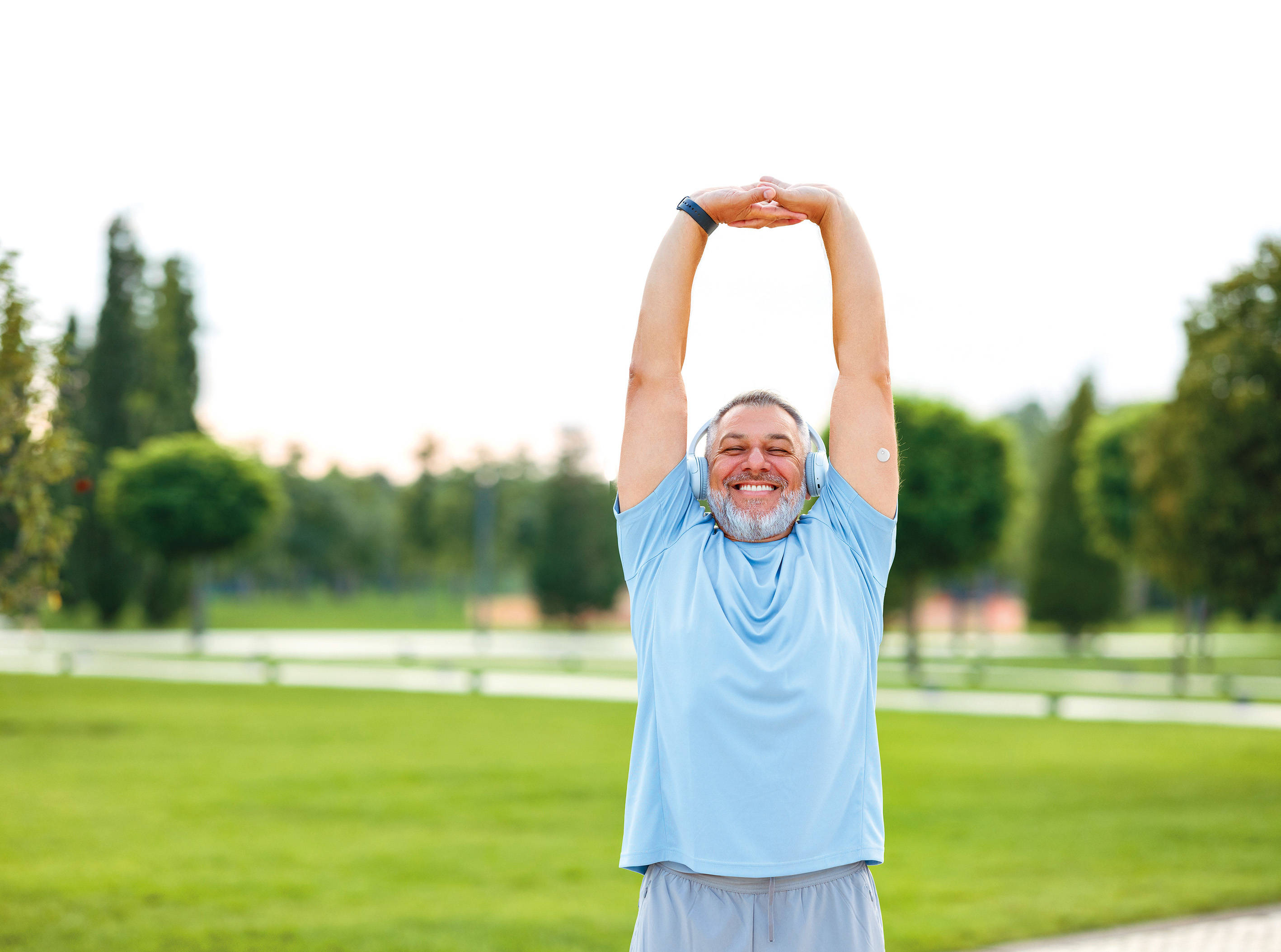 man with arms up and with sensor on arm
